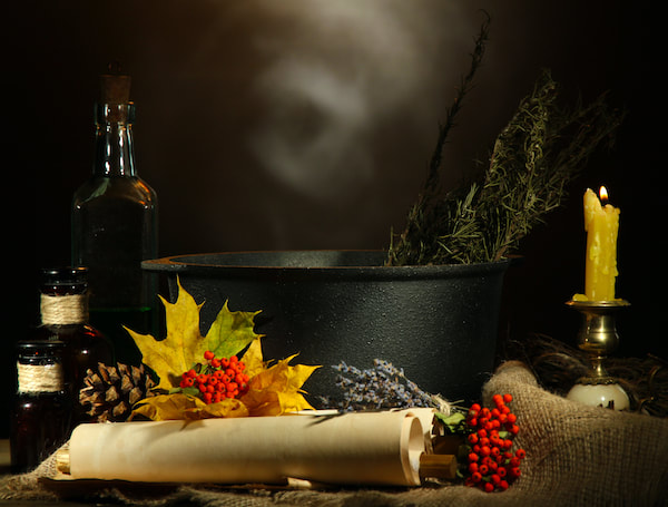 Cauldron, bottles, berries, leaves and a candle